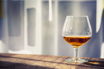 a glass of elite cognac on the bar
