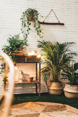 Modern terrace decorations with indoor and outdoor plants and flowers, wooden table, clay pots,...
