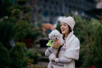 Beautiful young woman with a white dog