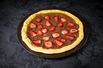 Pizza deliciosa com ingredientes na mesa de madeira com fundo escuro.