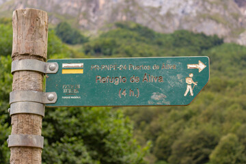 Fuente De, Spain - August 31, 2020: Wooden signpost with directional sign on hiking trail (Aliva...