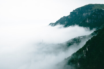 Mountain ridges and village covered in fog on Wugong Mountain in Jiangxi, China