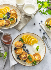 Delicious breakfast with curd fritter,  ricotta fritter or cottage cheese pancakes on ceramic plate. Gourmet healthy delicious morning breakfast. Morning sunny time