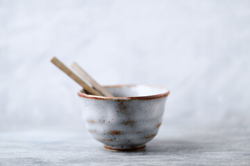 Tea culture. Traditional, handcrafted ceramic on bright wooden background. Copy space.