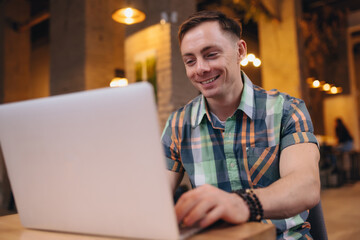 Man freelancer working using laptop in a cafe