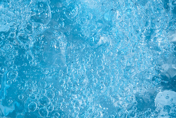 blue transparent clean drinking water abstract background. water surface with air bubbles background