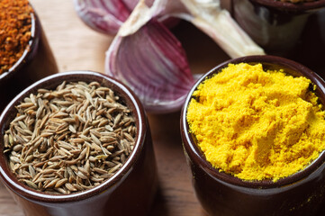 Spices and herbs in ceramic bowls. Food and cuisine ingredients. Colorful natural additives.