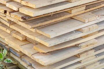 Natural unplaned wooden planks. Lumber construction material