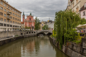 LJUBLJANA, SLOVENIA - MAY 13, 2019: Ljubljanica river and Franciscan Church of the Annunciation in Ljubljana, Slovenia