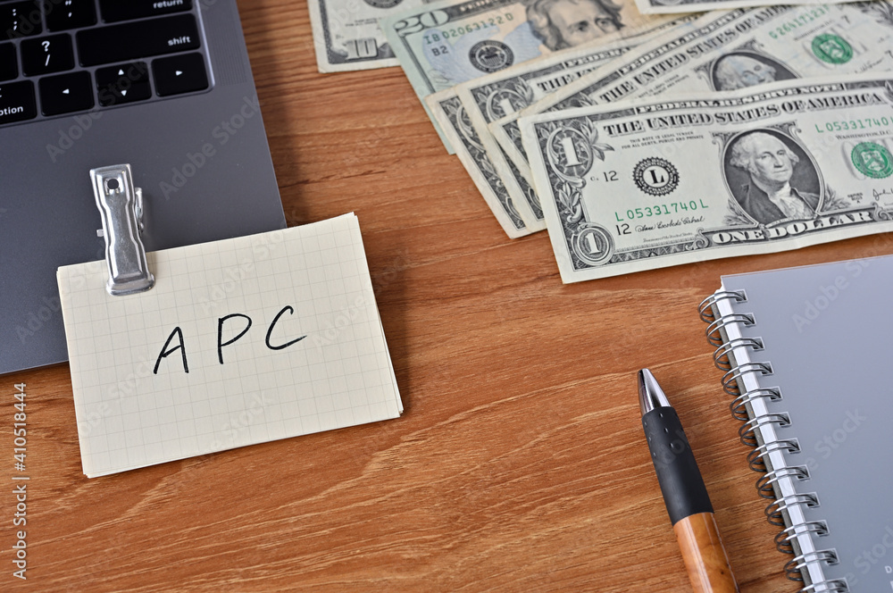 Poster on the desk there are bills, a keyboard, and memos with the word apc written on it. it was an abbrev