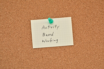 A piece of paper labeled Activity Based Working is pinned to the corkboard.