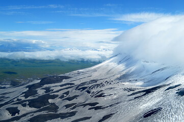 Snowcapped mountains seen from the helicopter on the way to the Valley of Geysers, Kamchatka peninsula, Russia.