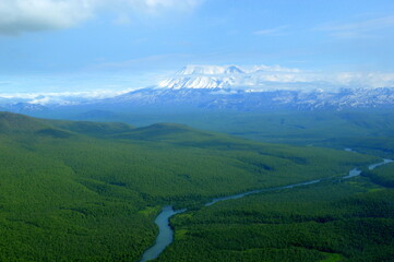 Snowcapped mountains seen from the helicopter on the way to the Valley of Geysers, Kamchatka peninsula, Russia.