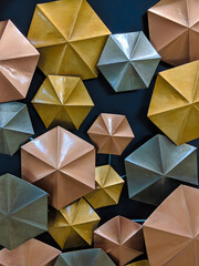 photo of a decorative arrangement of umbrella shapes in different colours.