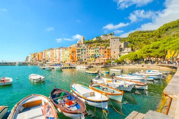 Papier Peint photo autocollant Ligurie Boats line the harbor of the colorful, touristic Italian city of Portovenere, along the Ligurian Coast of the Italian Riviera.