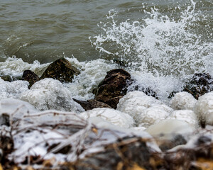 Wave crashing on rocky shore with spray