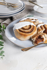 Cinnamon rolls or cinnabon  with icing for Christmas. Homemade traditional winter festive dessert buns. Pastry food for breakfast on white background