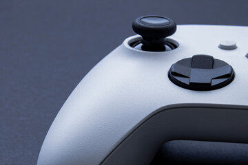 A Video game white control remote game pad on grey background