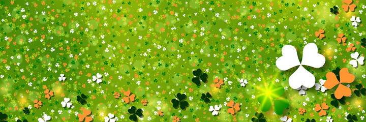 St.Patrick's Day green blurred vector background with colorful clover leaves