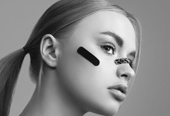 Fototapeta premium Beautiful blonde girl with glamour plasters on her face