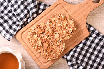Round shortbread almond biscuits on wooden tray 