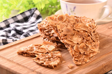 Round shortbread almond biscuits on wooden tray 