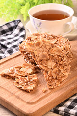 Round shortbread almond biscuits on wooden tray 