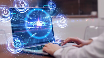 Fototapeta premium Business, Technology, Internet and network concept. Young businessman shows the word: Boost your business