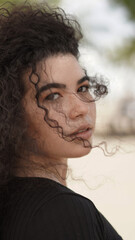 beautiful curly-haired white girl posing on a swing outdoors, young girl, curly hair, wearing glasses