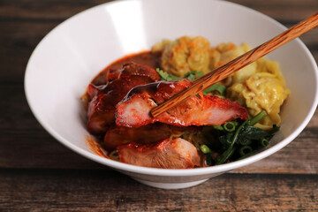 Shrimp dumpling with roasted pork with local thai tom yum spicy sauce on wood background