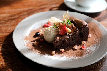 Chocolate cake with ice cream and coffee dessert on wood table