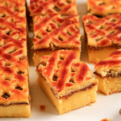 Nastar Cake, Lattice Pie, Pineaple Jam, and Chiffon Cake at the Bottom. Cut Square Slice on WHite Background. Delicious Homemade Cake