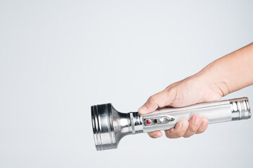 Hand holding vintage aluminium flashlight