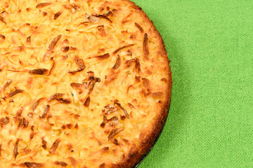 Whole cassava cake on green fabric background
