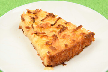 Whole cassava cake on green fabric background