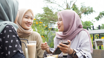 Asian hijab woman group smilling in cafe with friend