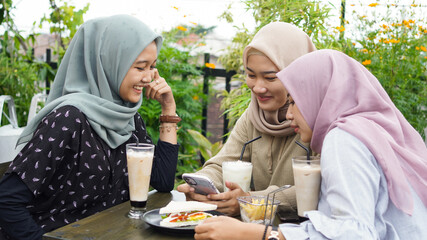 Asian group hijab woman smilling in cafe with friend