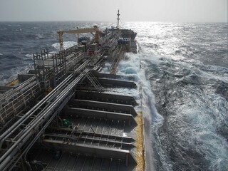 View from the bridge of a ship underway in Rough Sea. The ship is a chemical tanker with many pipelines fitted along the deck. A frammo type ship © Antony