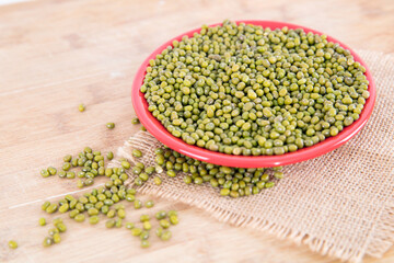 A plate of fresh mung beans and scattered beans