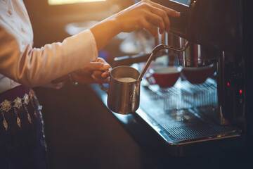 Barista making coffee in coffeeshop