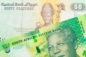 A macro image of a shiny, green 10 rand bill from South Africa paired up with a green and yellow fifty piastre note from Egypt.  Shot close up in macro.