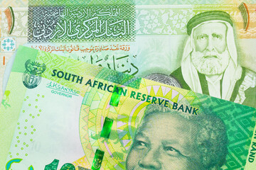 A macro image of a shiny, green 10 rand bill from South Africa paired up with a green and yellow one dinar note from Jordan.  Shot close up in macro. - obrazy, fototapety, plakaty