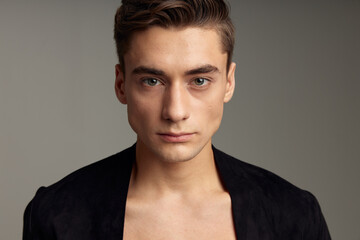 Obraz premium Handsome young guy fashionable hairstyle black jacket close-up attractiveness