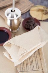 The traditional Chinese medicine and pestle on one side of the medical book and other related articles