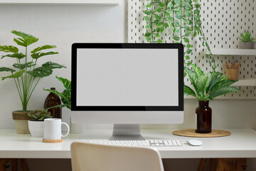 Biophilia workspace in home office room with computer, supplies and plants house