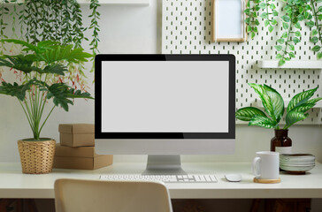 Biophilia workspace in home office room with computer, supplies and plants house