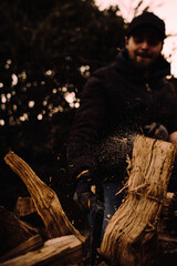Chopping logs for firewood in action and close up with particles flying