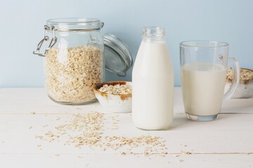 Vegan oat milk, non dairy alternative milk in a glass close up