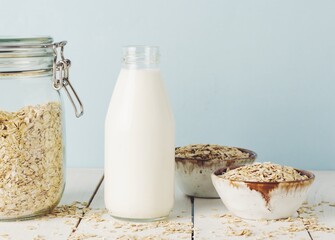 Vegan oat milk, non dairy alternative milk in a glass close up