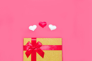 Happy Valentine's Day flatlay. Top view present gift box, hearts on on yellow color of the red background. panton